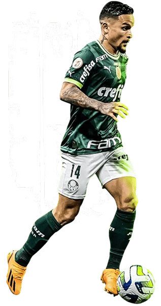 A soccer player wearing a green and white uniform, with the number 14, dribbles a ball. The background features a stylized white brushstroke design.